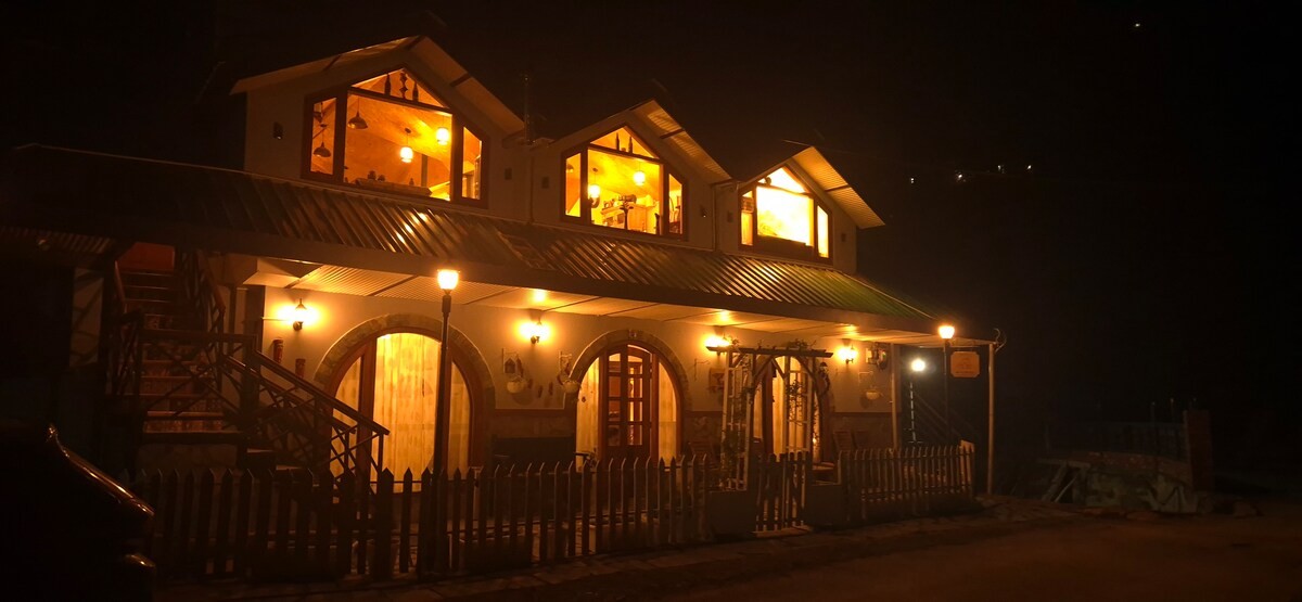 Roots n Rustle homestay lit up at night